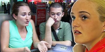 Three people talking at airport terminal desk