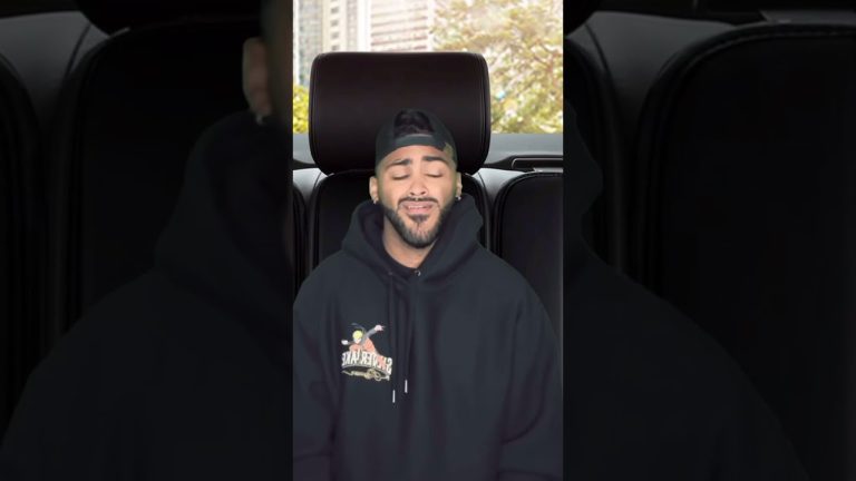 Person smiling in a car with hoodie