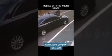 Black car on roadside, open door, traffic caution.
