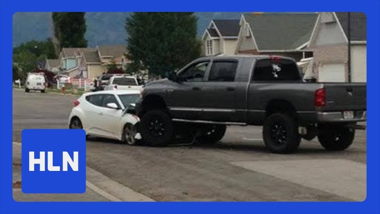 SUV on car after accident in residential area.