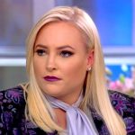 Person with blonde hair on a talk show set.