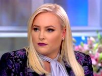 Person with blonde hair on a talk show set.