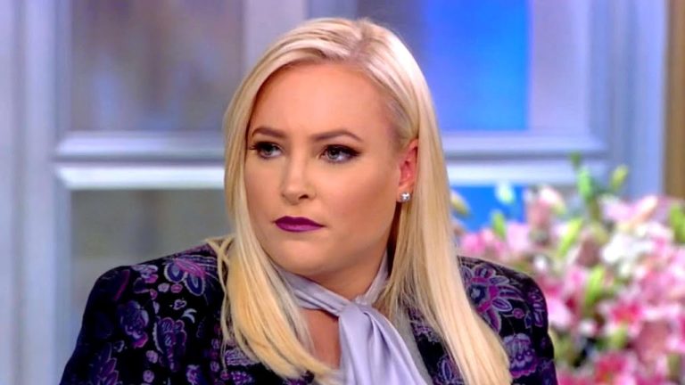 Person with blonde hair on a talk show set.