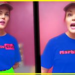 Person in Marble Slab uniform standing, pink background