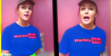 Person in Marble Slab uniform standing, pink background