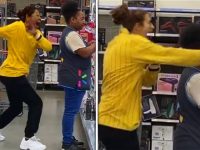 Two women laughing and dancing in a store.
