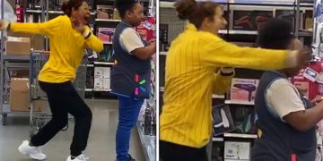 Two women laughing and dancing in a store.