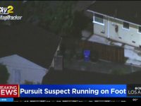 News helicopter view of police pursuit in residential area.