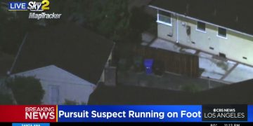 News helicopter view of police pursuit in residential area.