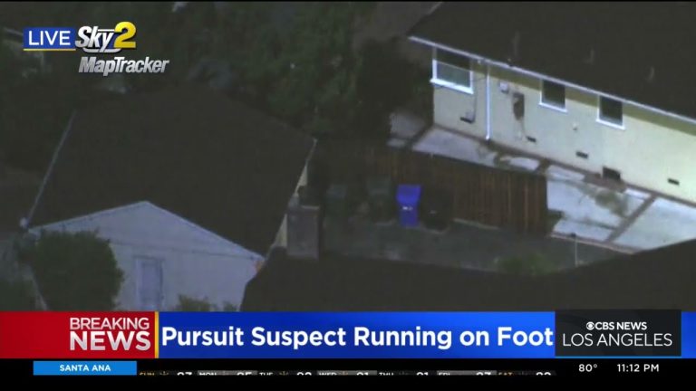News helicopter view of police pursuit in residential area.