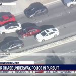 Aerial view of car chase on highway, Ontario, CA.