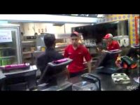 Fast food restaurant kitchen with workers.