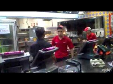 Fast food restaurant kitchen with workers.