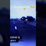 Motorcyclist riding on dimly lit road.