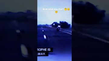 Motorcyclist riding on dimly lit road.