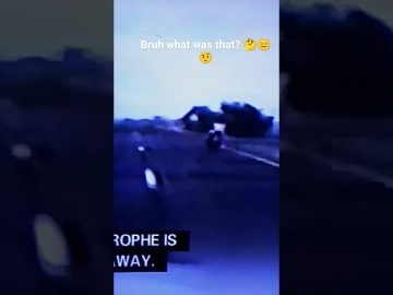 Motorcyclist riding on dimly lit road.