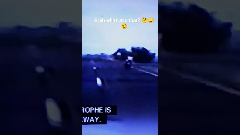 Motorcyclist riding on dimly lit road.