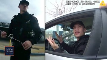 Police officer interacting with person in car.