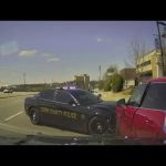 Police car ramming red vehicle on city street.