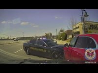 Police car ramming red vehicle on city street.