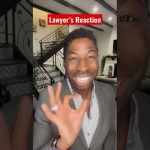 Smiling person gives okay gesture indoors.