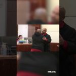 Judge embraces man in courtroom.