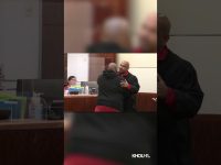 Judge embraces man in courtroom.