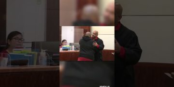 Judge embraces man in courtroom.