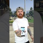 Person holding phone in outdoor setting.