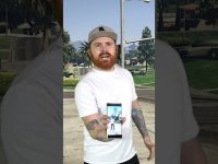 Person holding phone in outdoor setting.