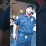 Security officer talking on phone inside building.