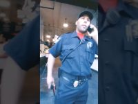 Security officer talking on phone inside building.