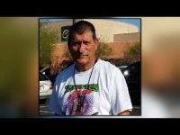 Man in graphic t-shirt outdoors, close-up