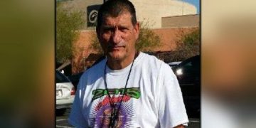 Man in graphic t-shirt outdoors, close-up