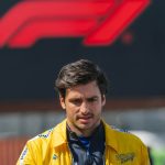 Man in yellow jacket, Formula 1 logo background.