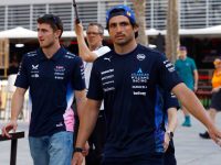 Two race team members walking in paddock.