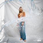 Woman standing behind splashing water.