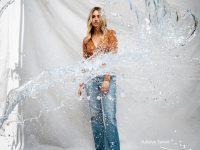 Woman standing behind splashing water.