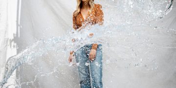 Woman standing behind splashing water.