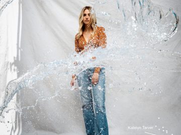 Woman standing behind splashing water.
