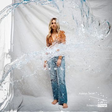 Woman standing behind splashing water.