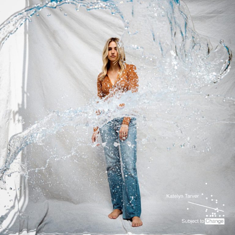 Woman standing behind splashing water.
