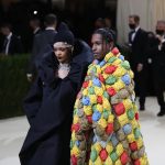 Fashionable couple at elegant event in creative outfits.