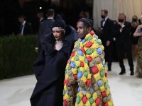 Fashionable couple at elegant event in creative outfits.