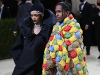 Fashionable couple at a gala in elaborate outfits.