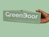 Hand holding GreenDoor box with Aristotle quote.