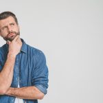 Thoughtful person in denim shirt, looking contemplative.