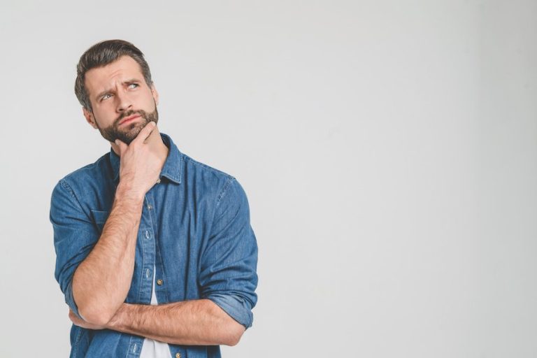 Thoughtful person in denim shirt, looking contemplative.