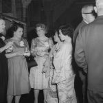 People socializing at a formal event.