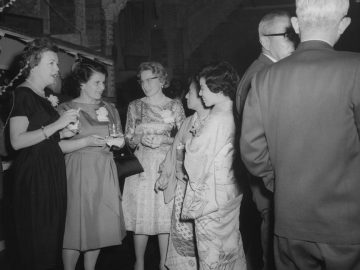 People socializing at a formal event.